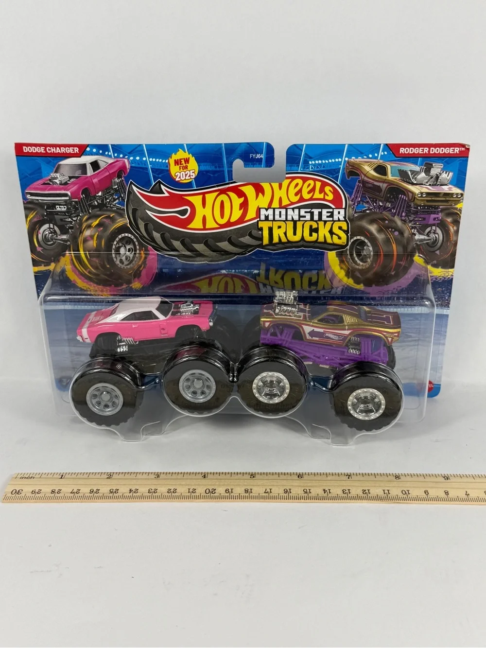 Hot Wheels monster trucks, Pink Dodge Charger, and Purple Roger Dodger. New
